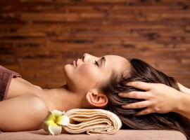 Masseur doing massage the head and hair for an woman in spa salo
